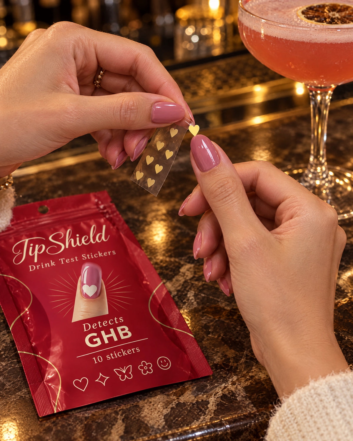 Applying a TipShield sticker to a nail at the bar